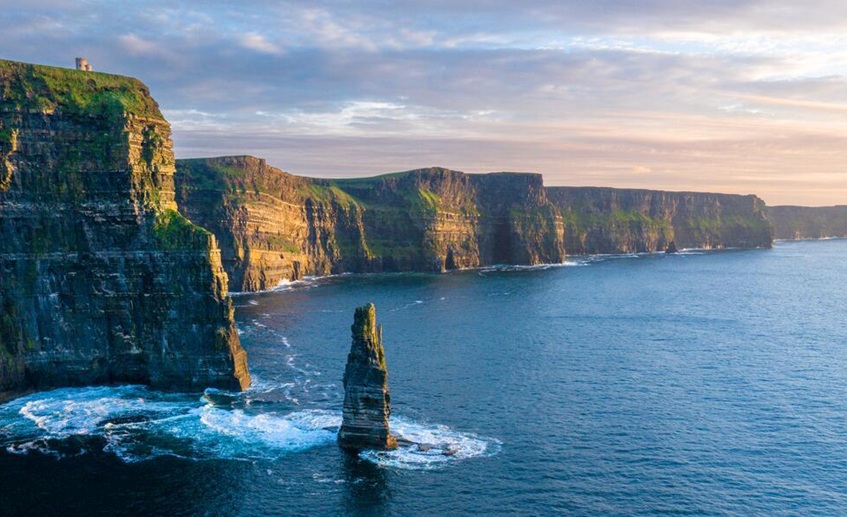 Coastal cliffs and sea stack overlooking the ocean.