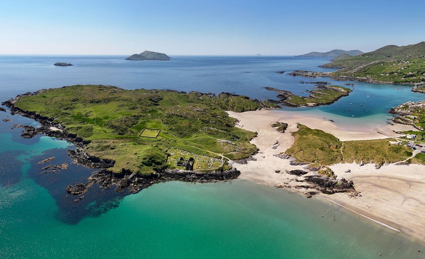 Aerial view of beach, sea and islands with blue sky.
