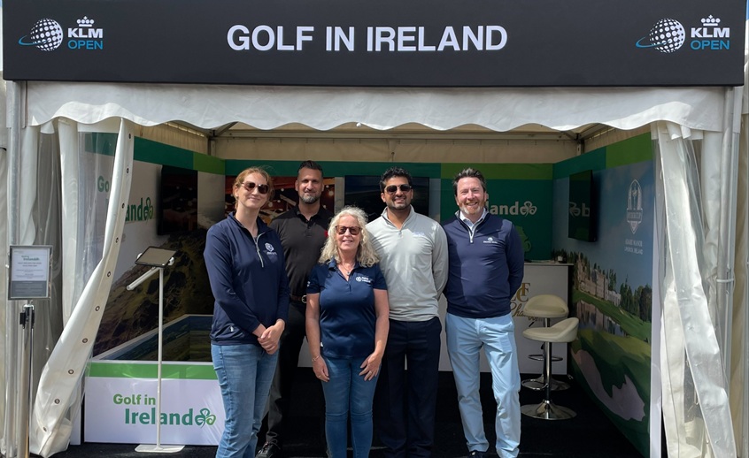 Five people in front of a promotion stand saying 'Golf in Ireland'.