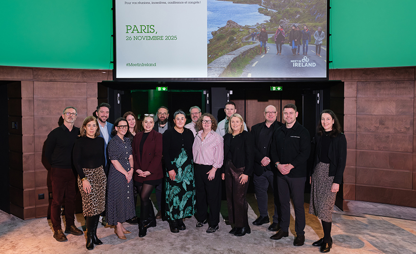 Group photo at an indoor event in front of a screen showing “Paris, 26 Novembre 2025” and Meet in Ireland branding.