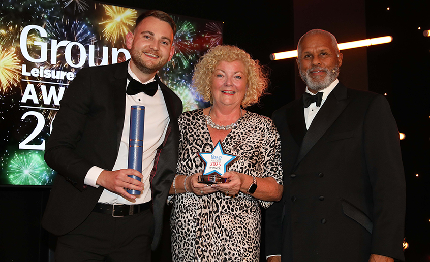 Three people holding an award with a Group Leisure & Travel Award background behind them