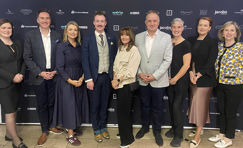A group of people standing together indoors at the event.