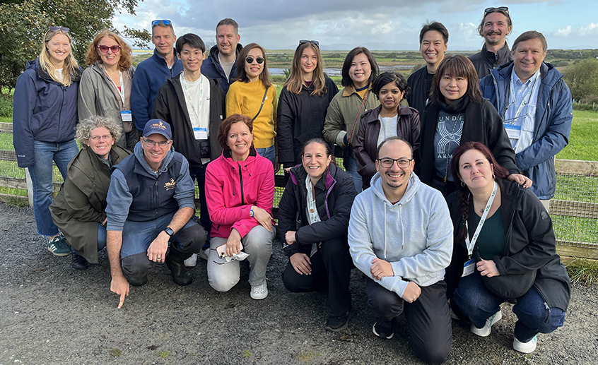 Group of international inbound tour operators posing outdoors at a scenic Irish countryside location during a tourism familiarisation trip.