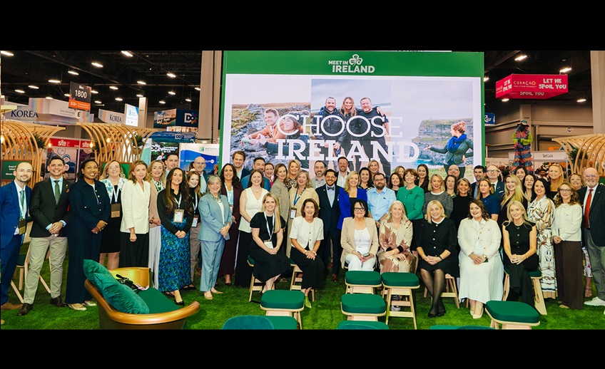 Group photo of tourism industry representatives at the Meet in Ireland stand at a trade exhibition, in front of a large “Choose Ireland” display.