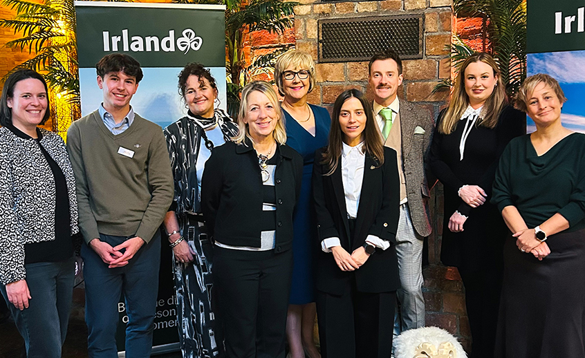 Group photo of eight tourism and business representatives at a Tourism Ireland networking event.