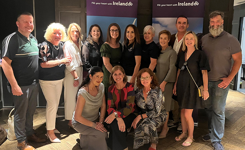 A group of people posing in front of two pull up stands with 'Fill Your Heart with Ireland'  banners.