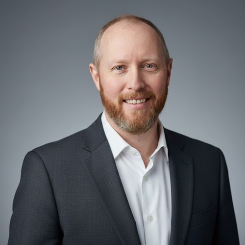 Head and shoulders picture of Barry Flanagan in a business suit with a grey background