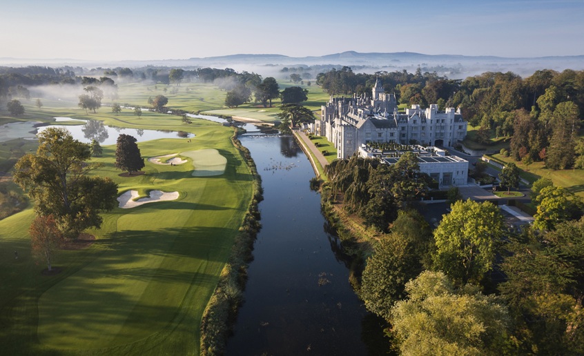 Adare Manor Hotel aerial picture with golf course, river and mountains in background.