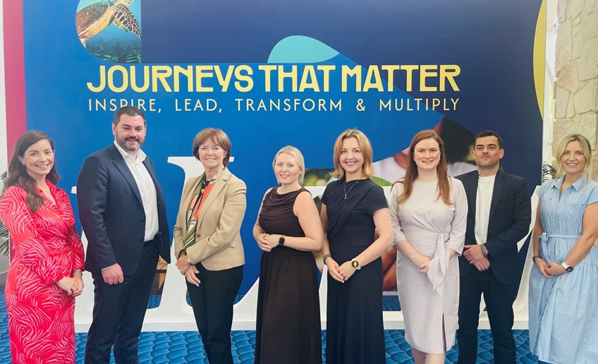 Staff group in front of a Tourism Ireland “Journeys That Matter” display.