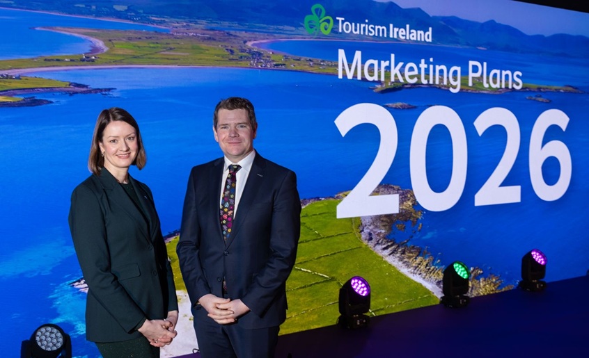 Two people pictured in front of a scenic presentation saying Tourism Ireland Marketing Plans 2026