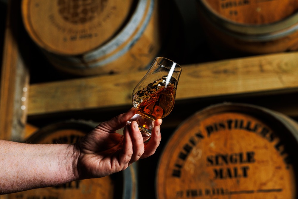 A glass of whiskey in a distillery