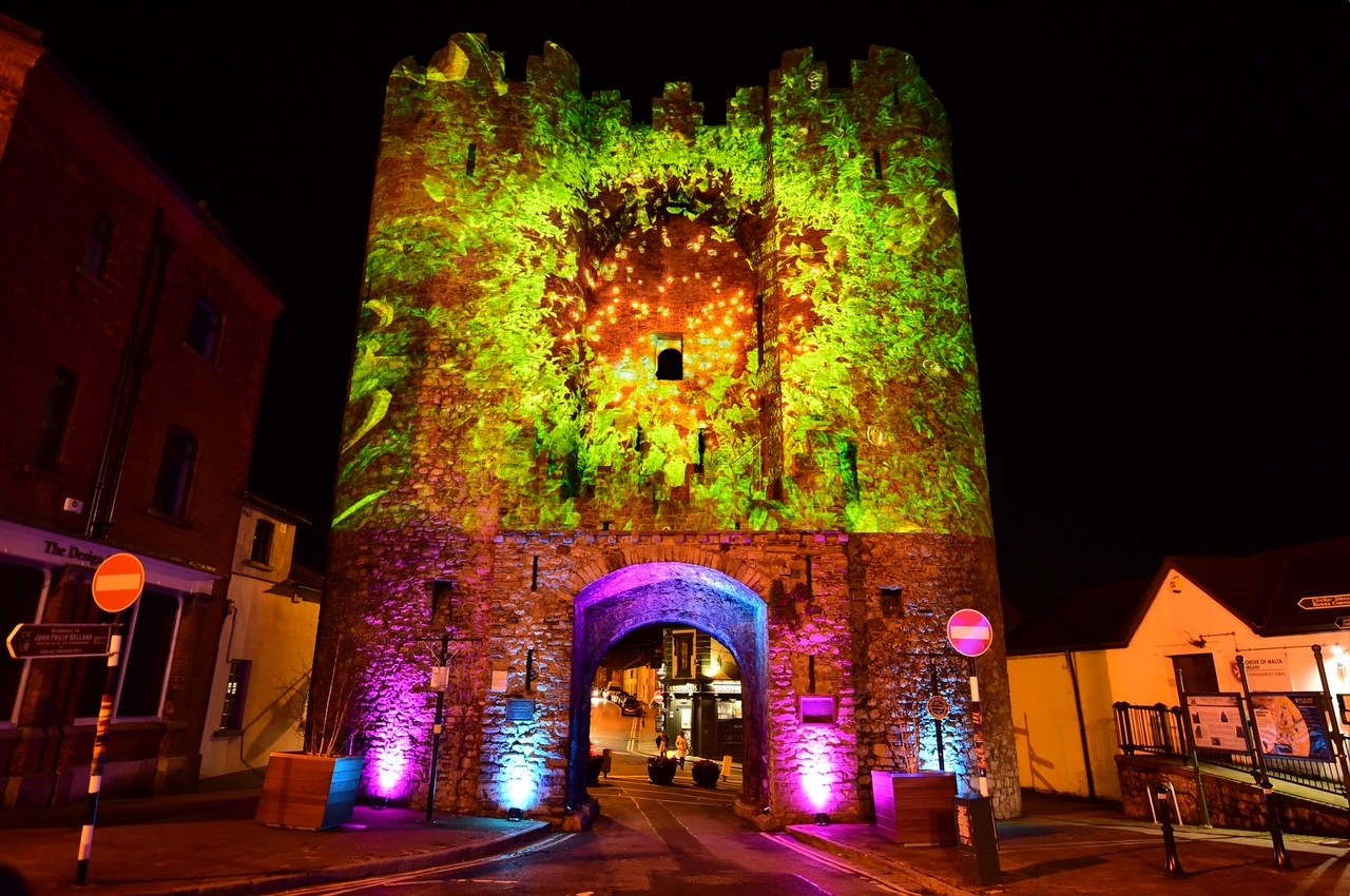 Image of lights being projected at St Lawrences Gate at night