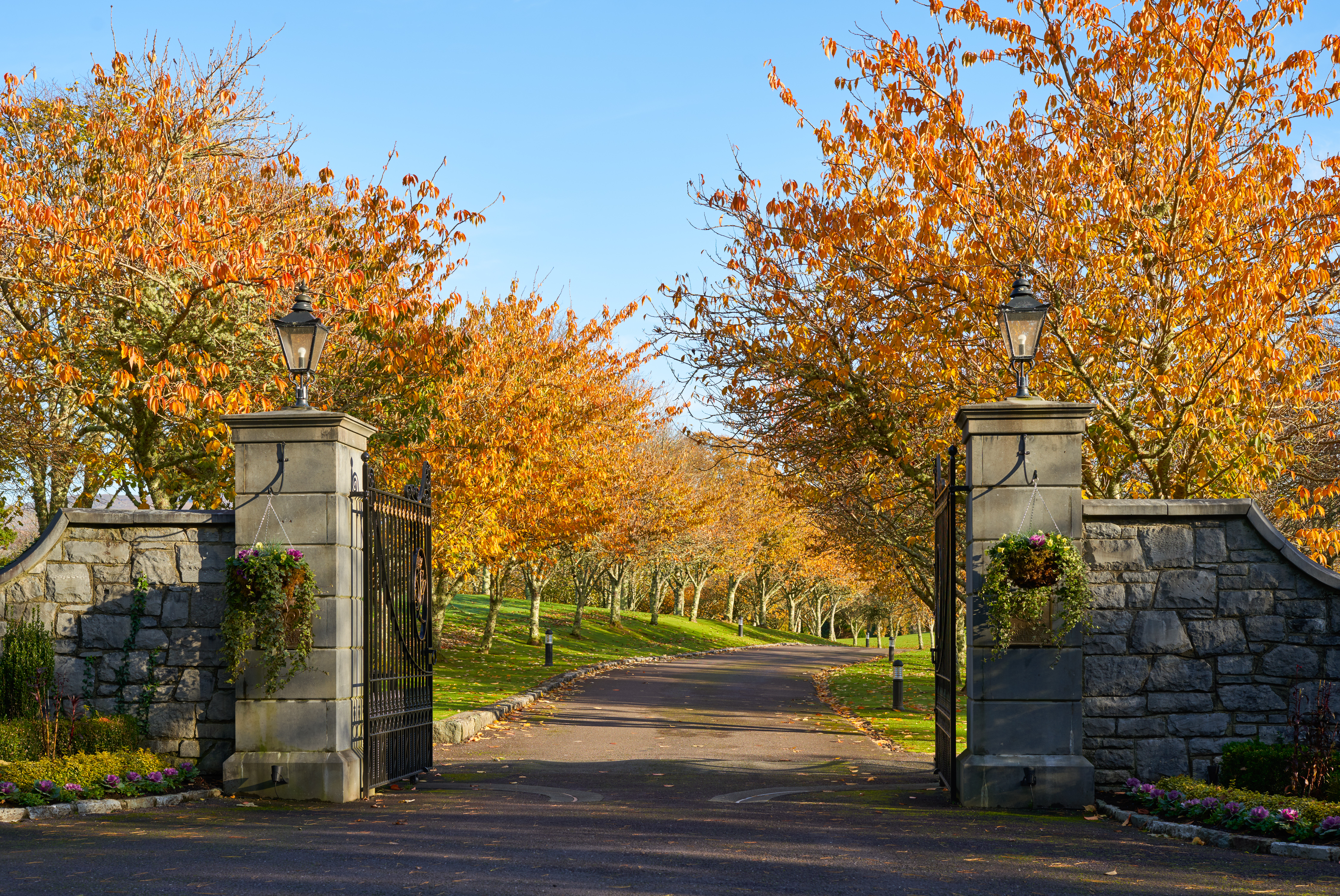 An autumnal exterior image of the Sheen Falls gates