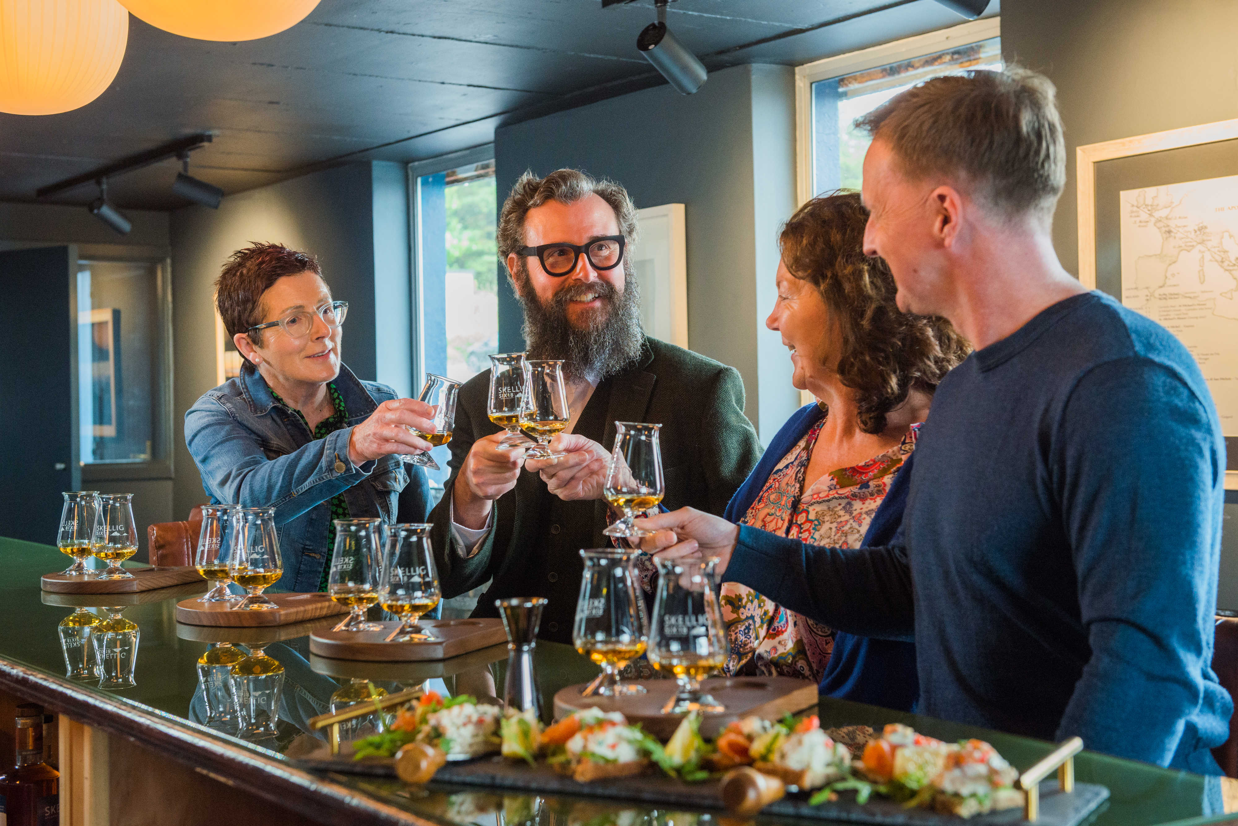 the snug experience guests raisin a glass during a guided tasting of skellig six18